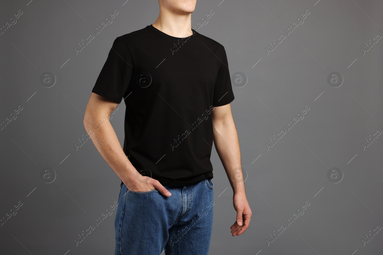 Photo of Man in stylish t-shirt on grey background, closeup. Mockup for design