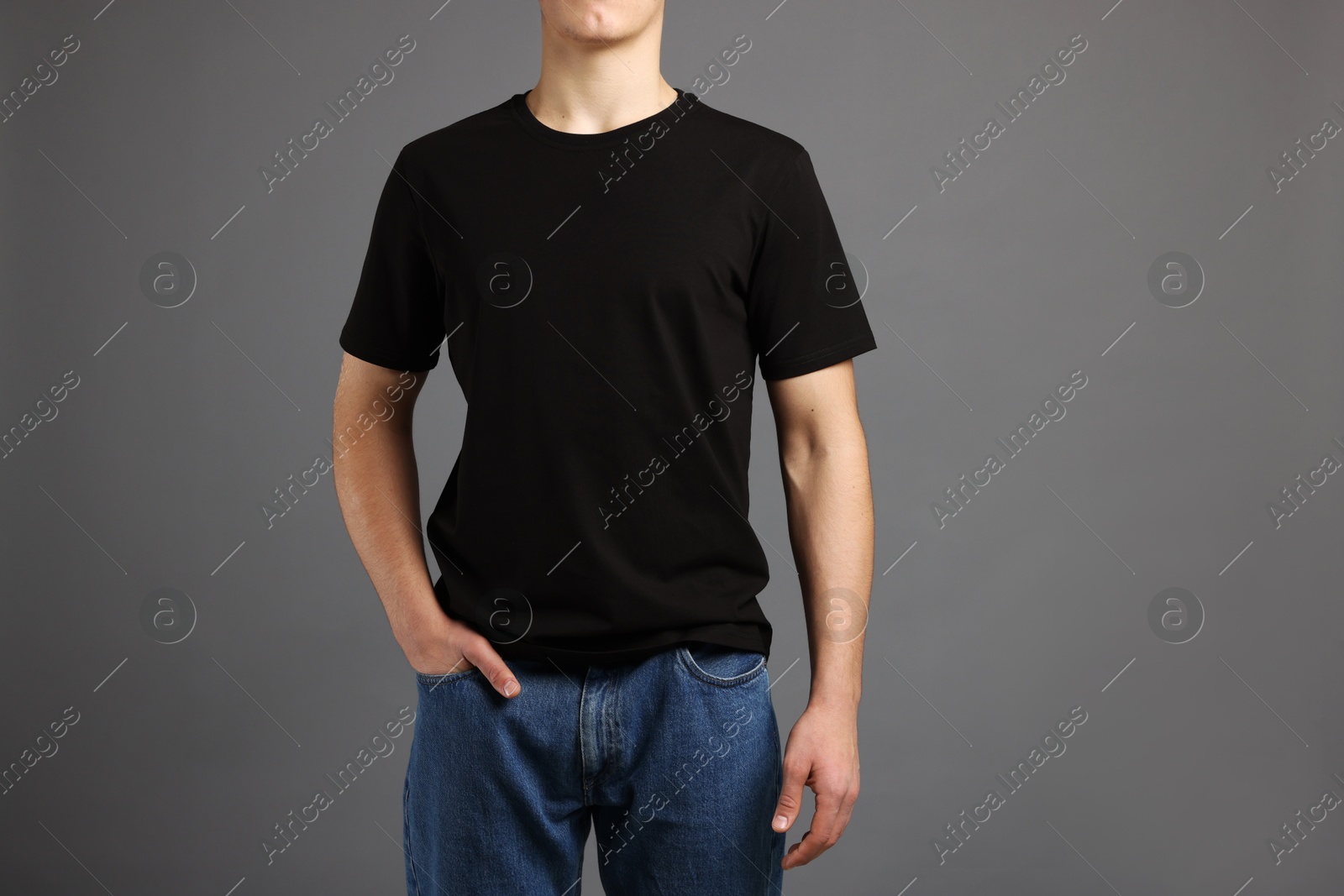 Photo of Man in stylish t-shirt on grey background, closeup. Mockup for design