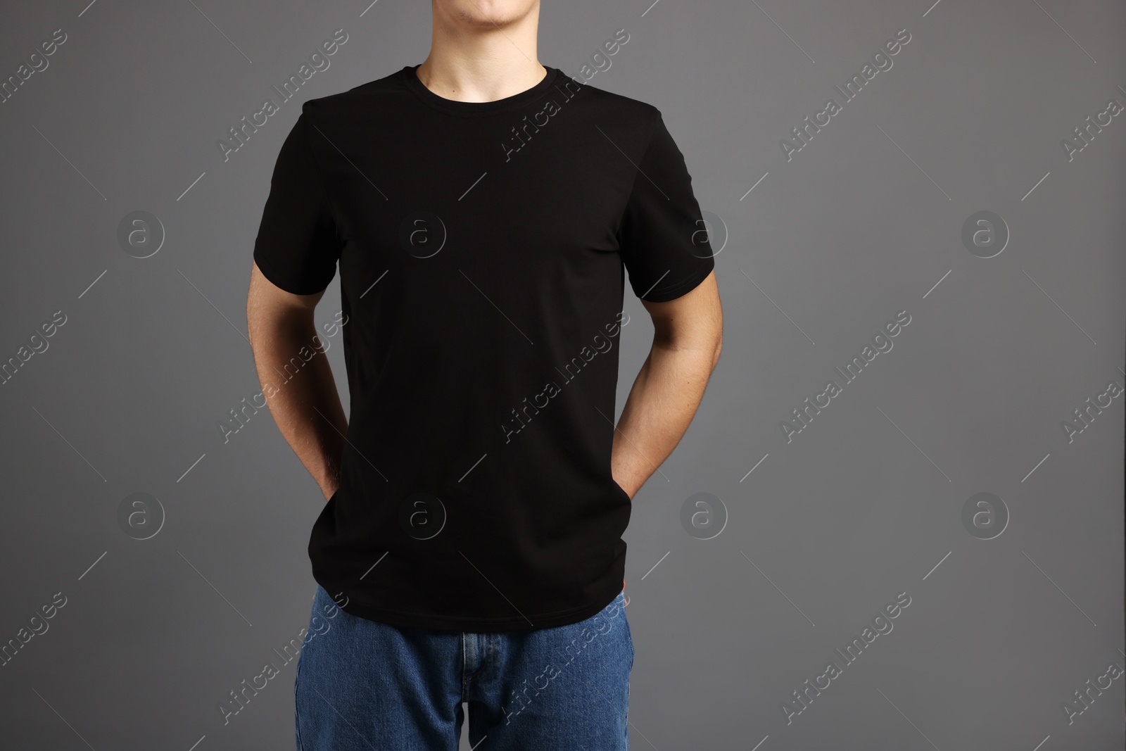 Photo of Man in stylish t-shirt on grey background, closeup. Mockup for design