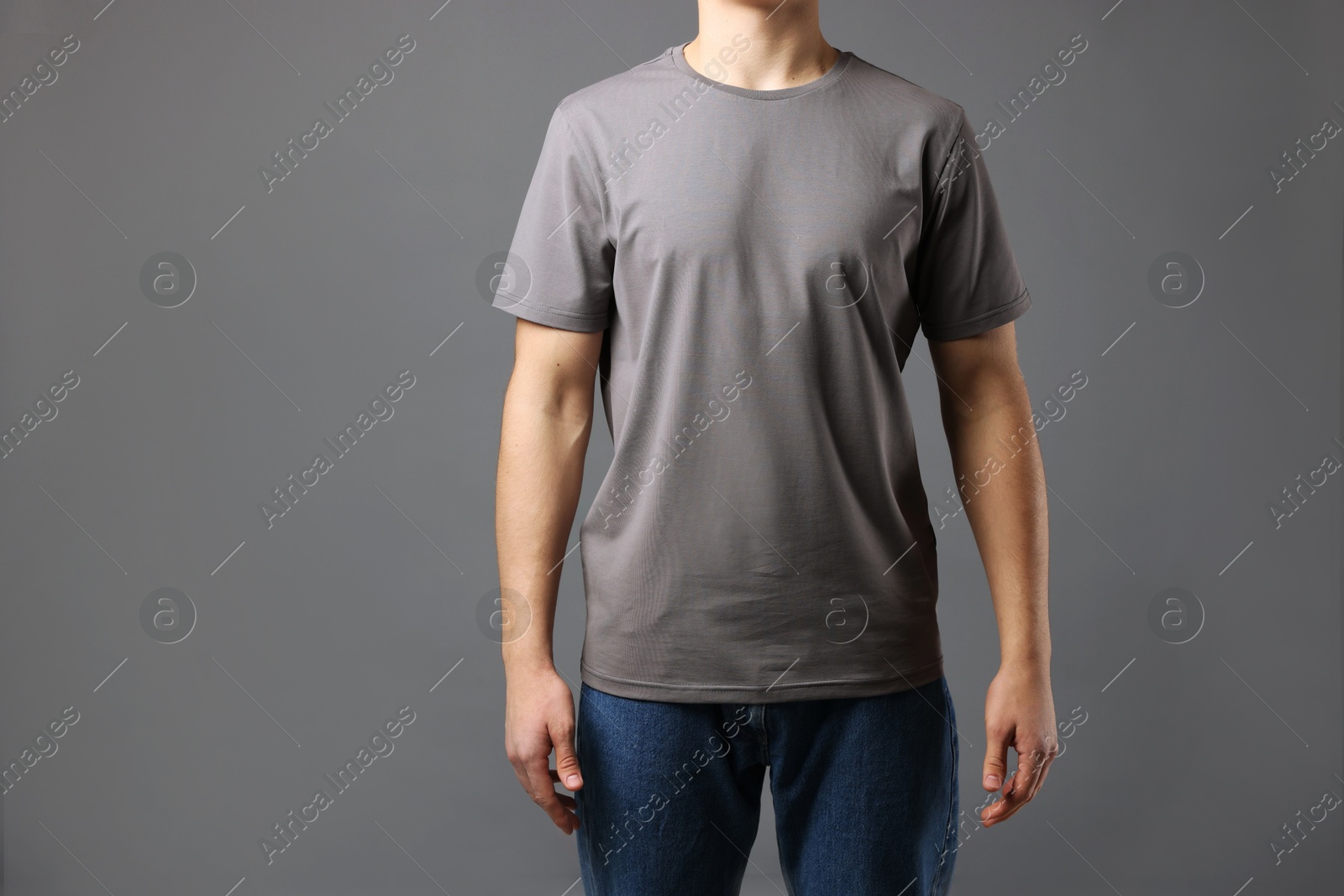 Photo of Man in stylish t-shirt on grey background, closeup. Mockup for design