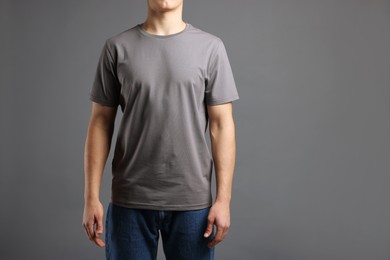 Photo of Man in stylish t-shirt on grey background, closeup. Mockup for design