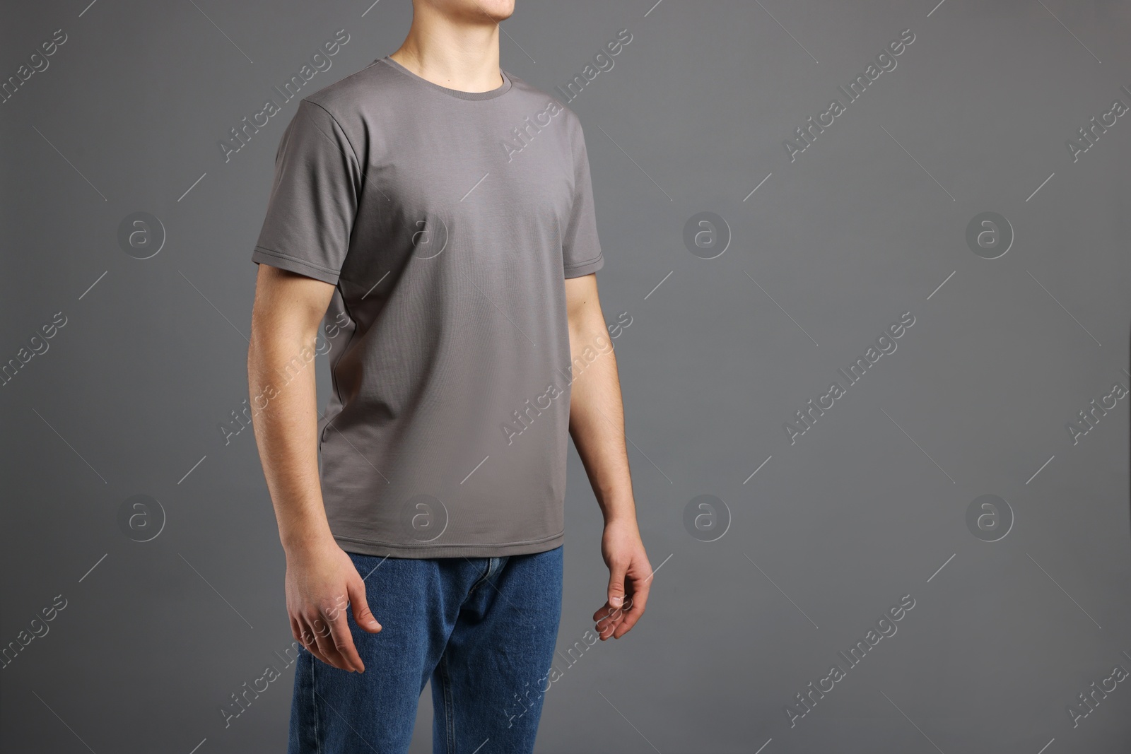 Photo of Man in stylish t-shirt on grey background, closeup. Mockup for design