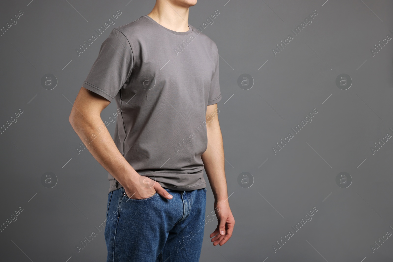 Photo of Man in stylish t-shirt on grey background, closeup. Mockup for design