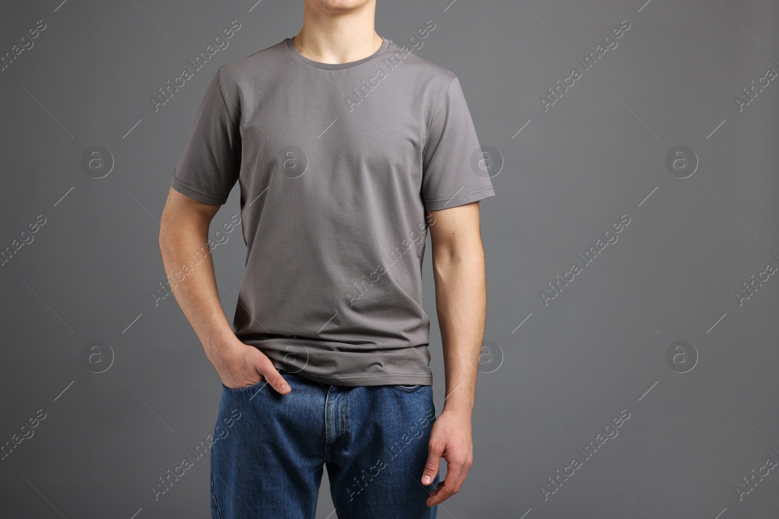 Photo of Man in stylish t-shirt on grey background, closeup. Mockup for design