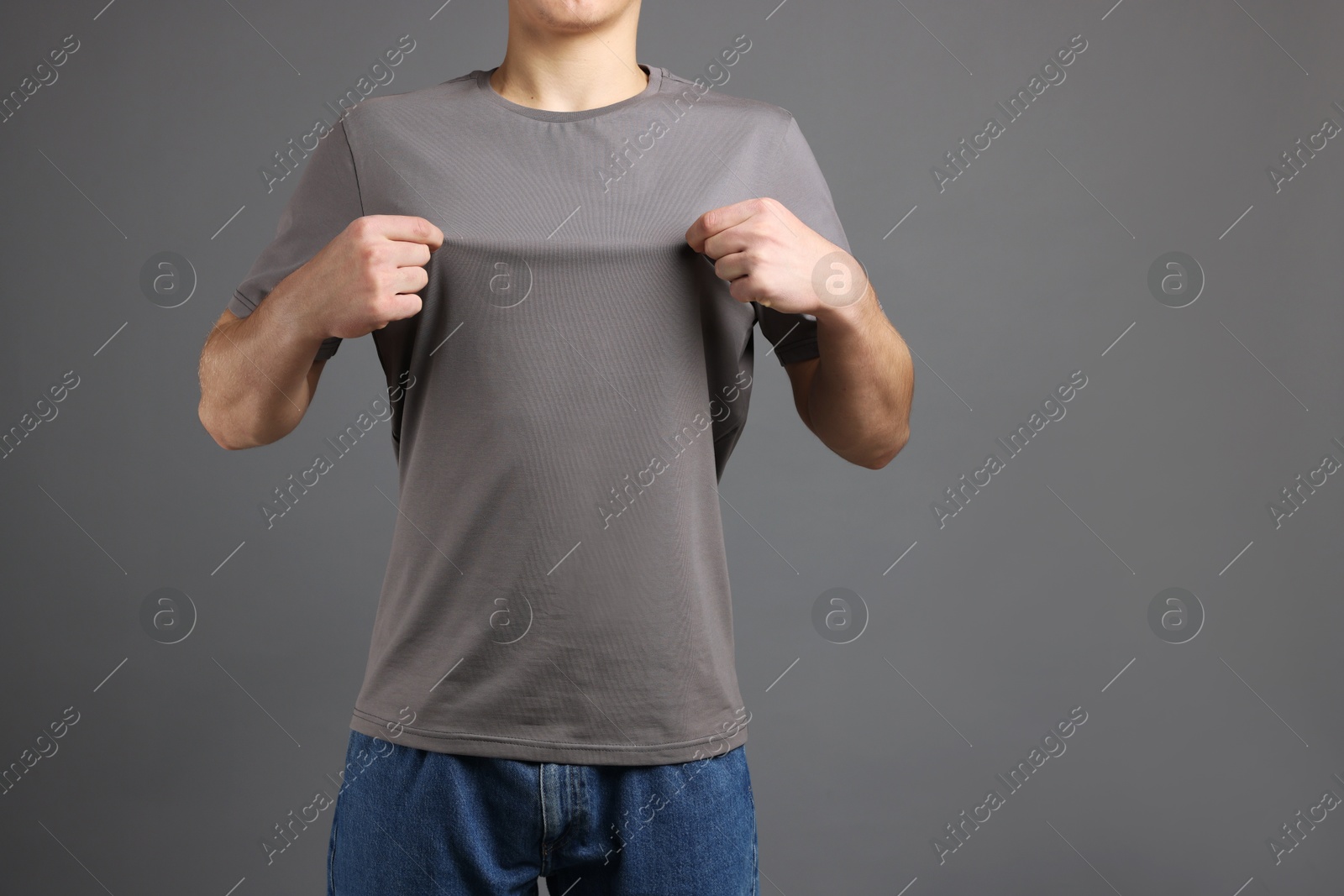 Photo of Man in stylish t-shirt on grey background, closeup. Mockup for design