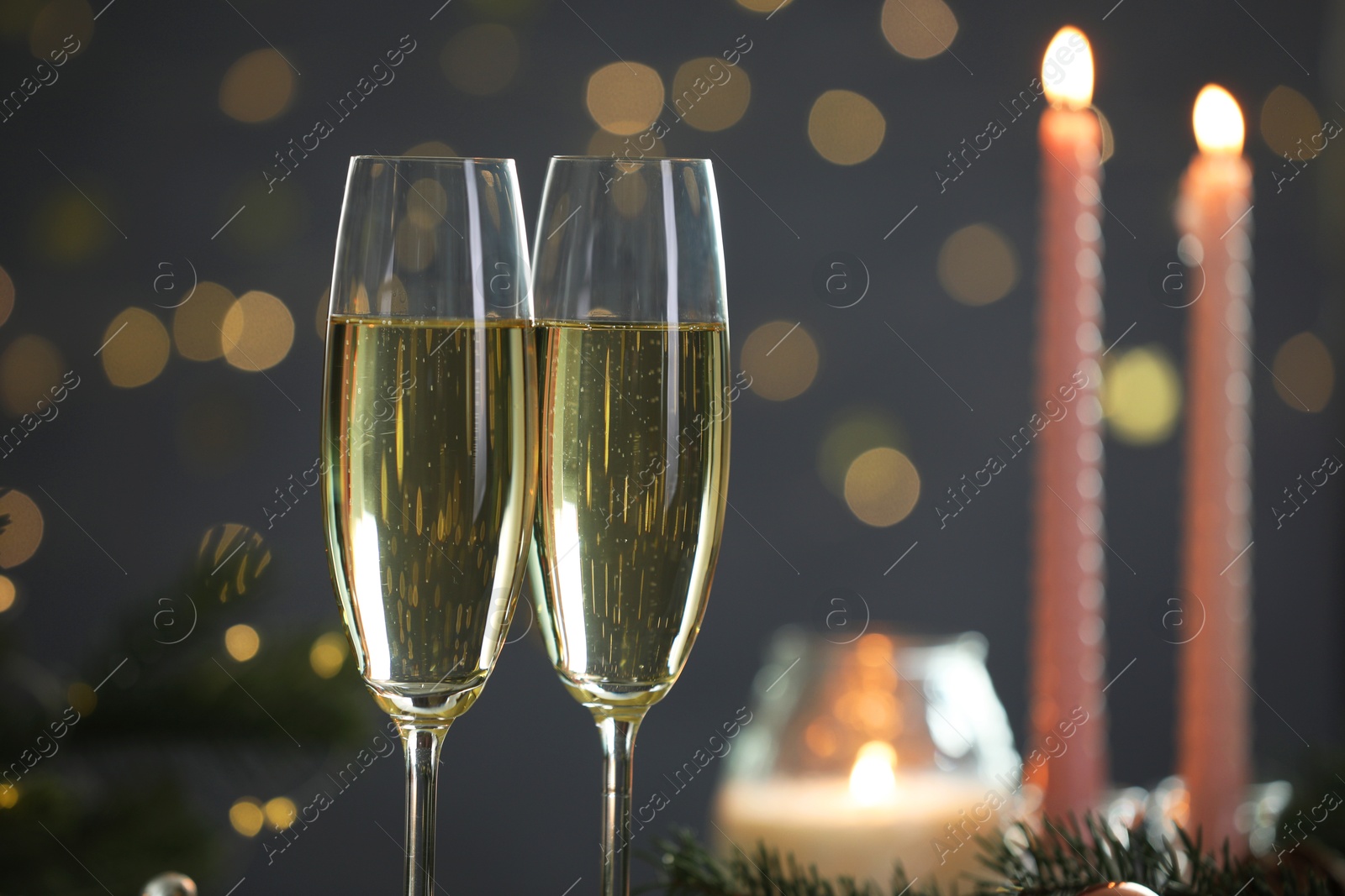 Photo of Delicious champagne in glasses against blurred lights, closeup. Christmas celebration