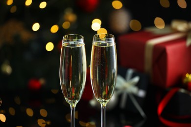 Photo of Delicious champagne in glasses against blurred lights, closeup. Christmas celebration