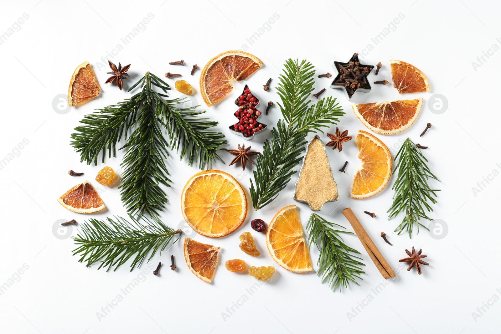 Photo of Different spices, dried orange slices and fir tree branches on white table, flat lay. Christmas season