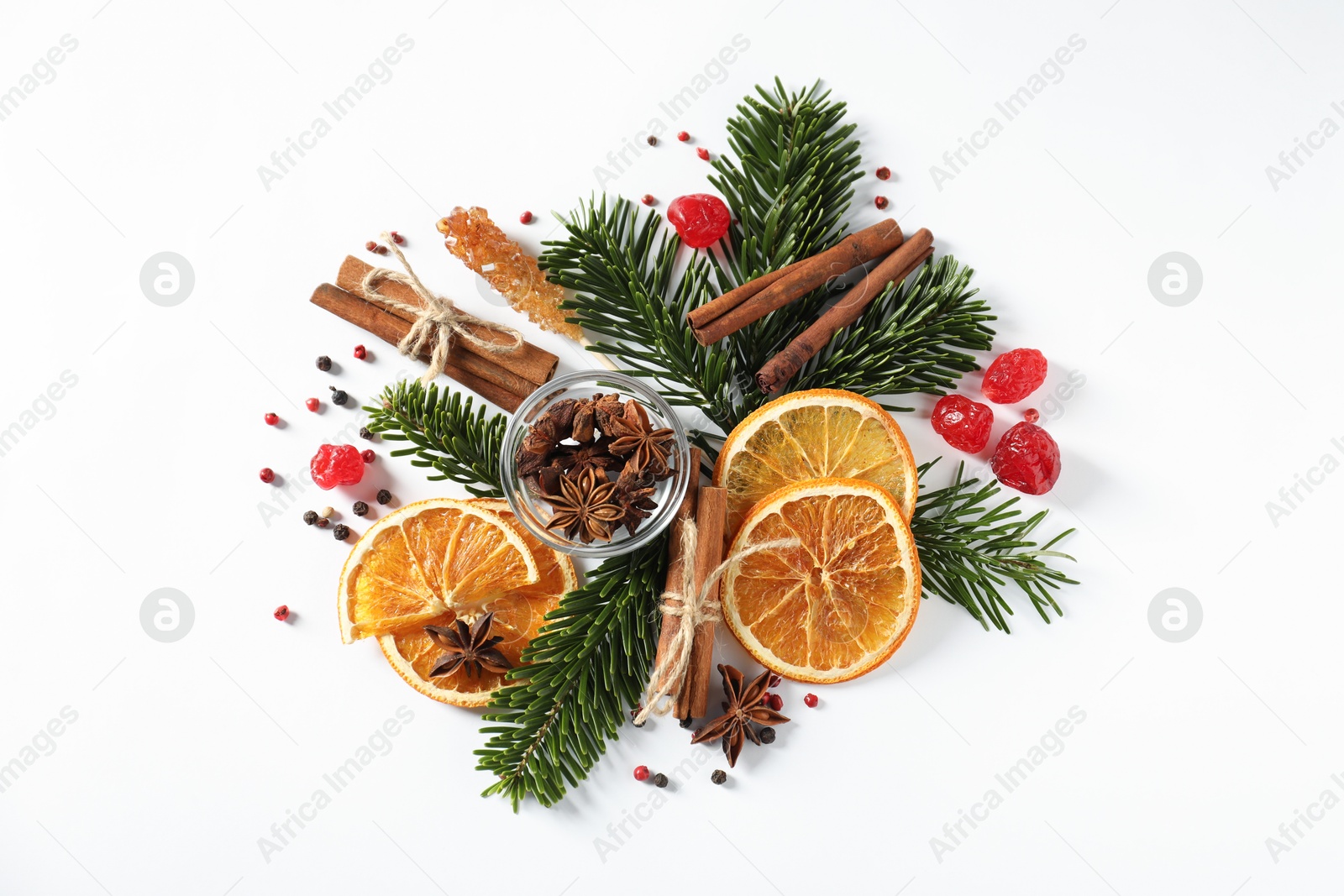 Photo of Different spices, dried orange slices and fir tree branches on white table, flat lay. Christmas season