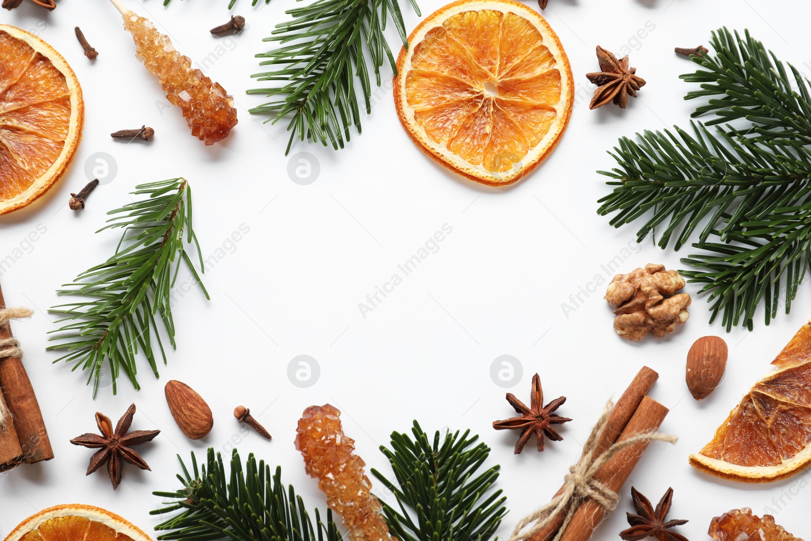 Photo of Different spices, dried orange slices and fir tree branches on white table, flat lay with space for text. Christmas season