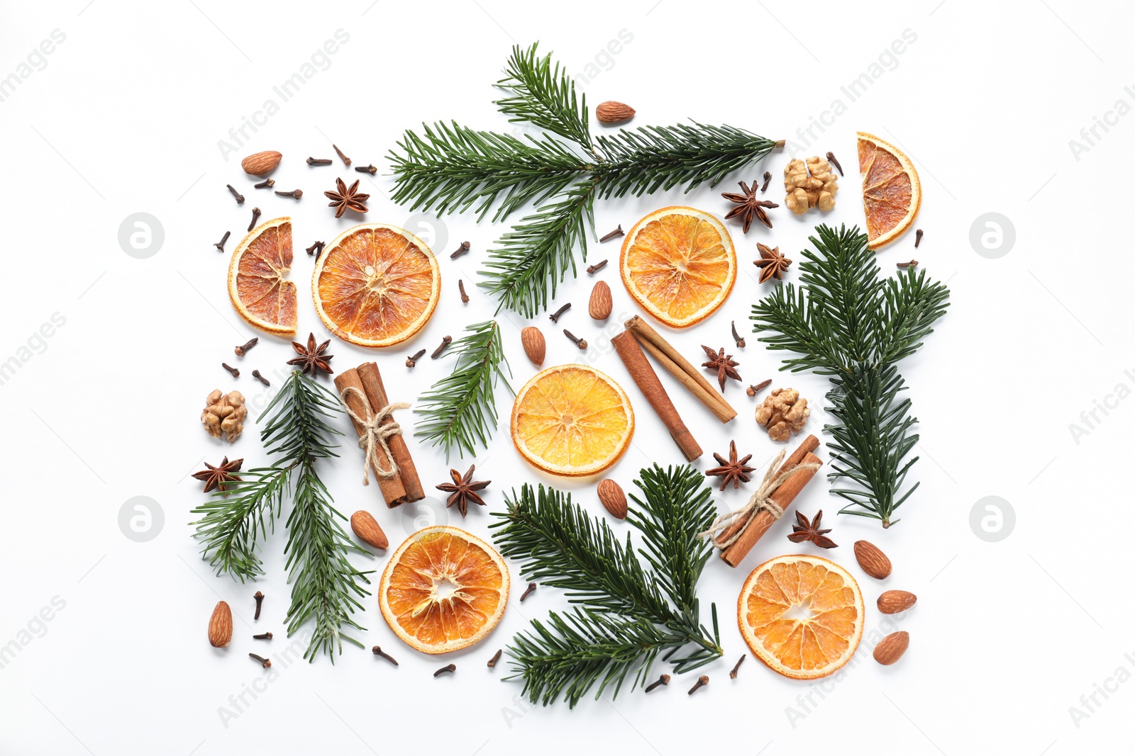 Photo of Different spices, dried orange slices and fir tree branches on white table, flat lay. Christmas season