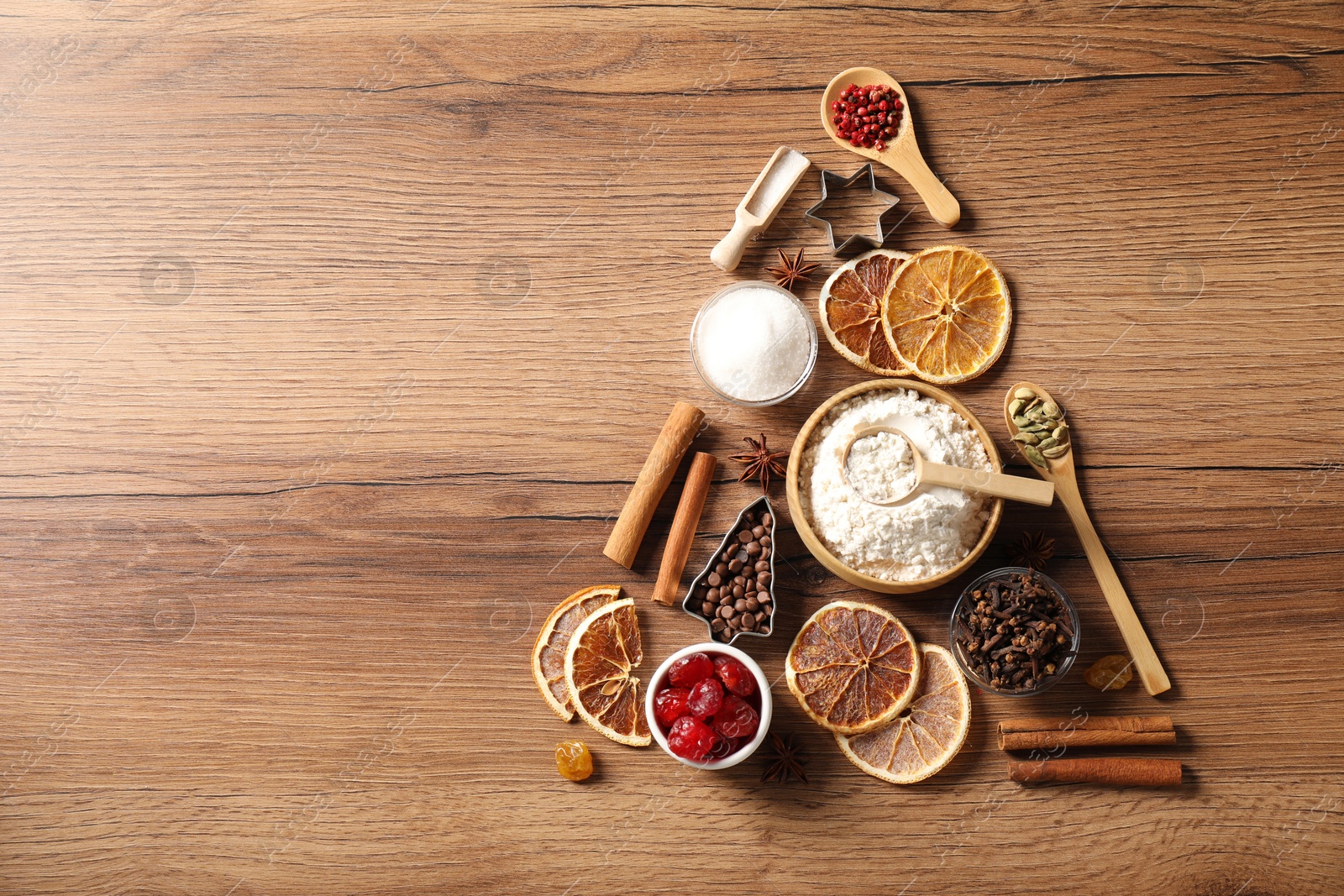 Photo of Christmas tree made with different aromatic spices on wooden table, top view. Space for text