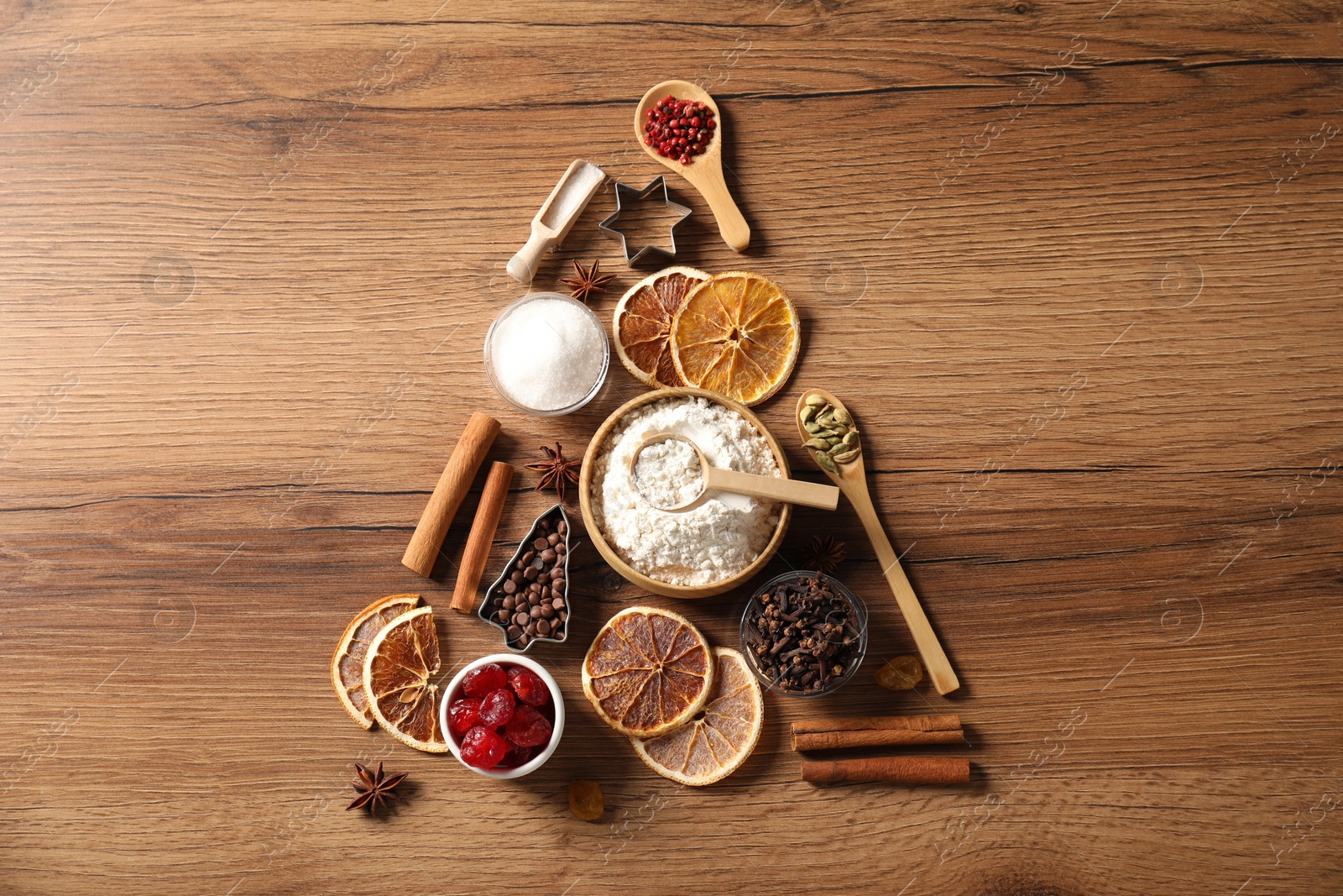 Photo of Christmas tree made with different aromatic spices on wooden table, top view