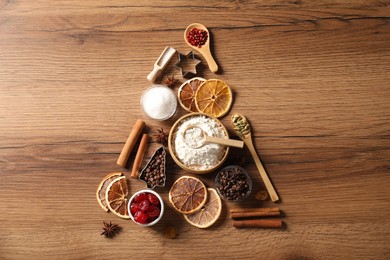 Photo of Christmas tree made with different aromatic spices on wooden table, top view