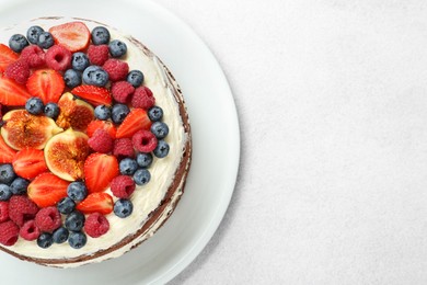 Photo of Delicious chocolate sponge cake with berries on light table, top view. Space for text