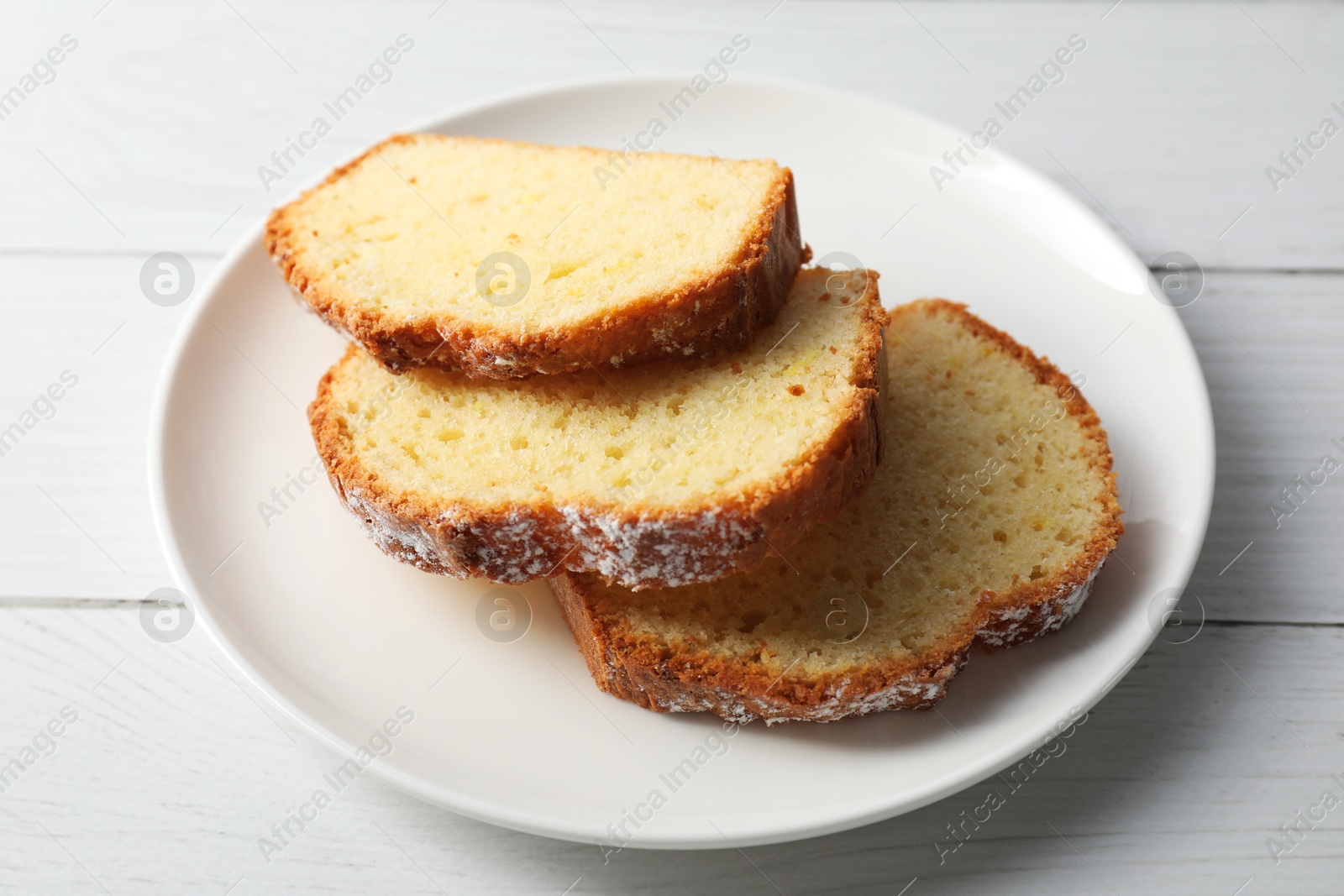 Photo of Freshly baked sponge cake on white wooden table