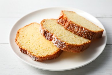 Photo of Freshly baked sponge cake on white wooden table, closeup