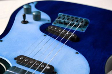 Image of Blue electric guitar on white background, closeup. Musical instrument