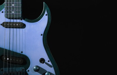 Image of Colorful electric guitar on black background. Musical instrument