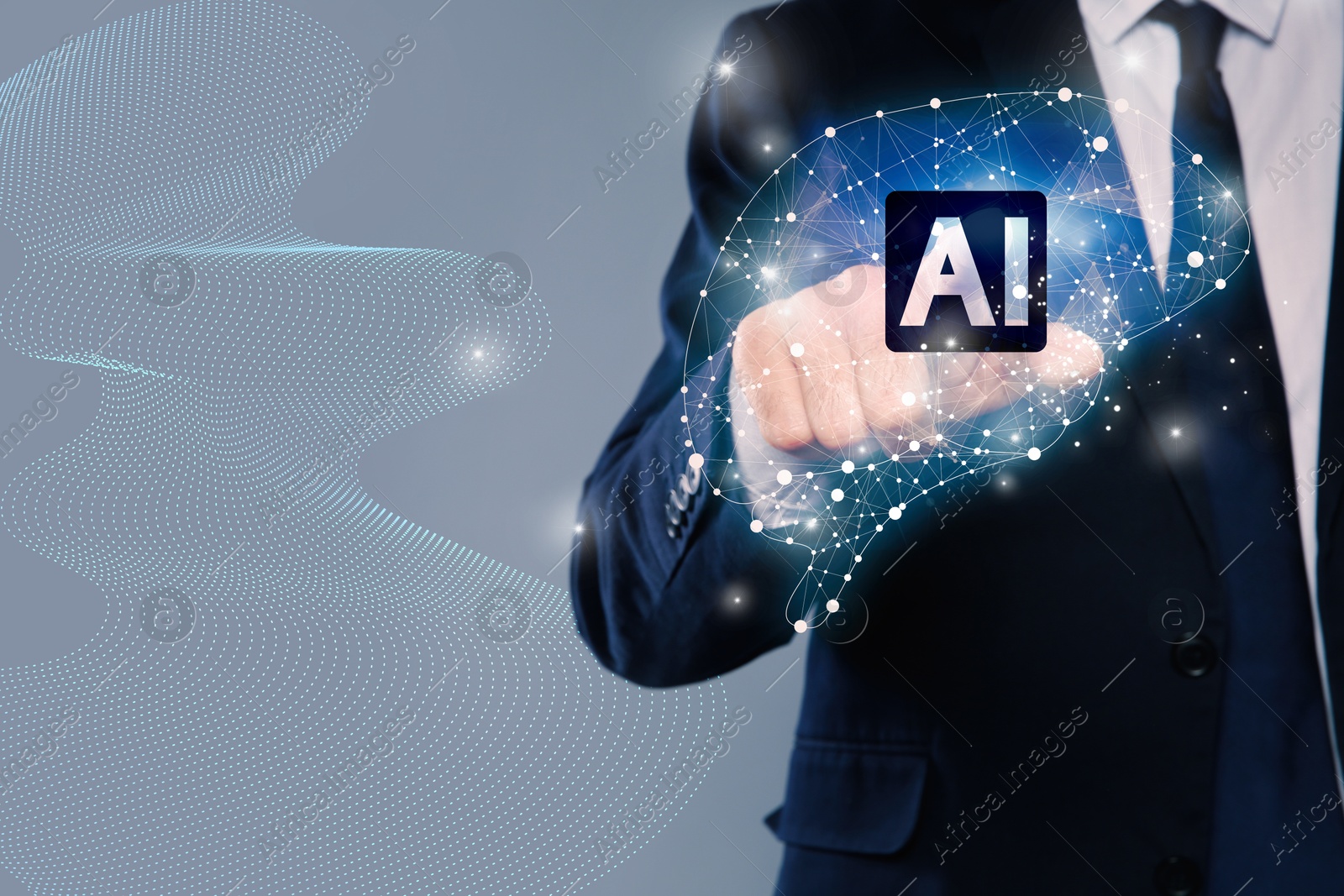 Image of Artificial intelligence. Businessman touching virtual brain with AI chip on grey background, closeup