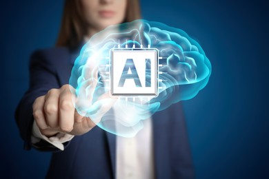 Image of Artificial intelligence. Businesswoman touching virtual brain with AI chip on dark blue background, closeup