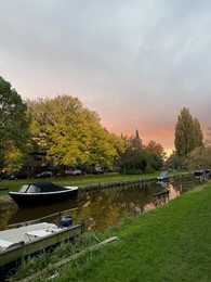 Photo of Beautiful view of canal with moored boats on autumn day