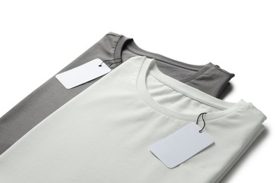 Image of White and grey t-shirts with tags on white background. Mockup for design