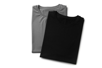 Image of Black and grey t-shirts on white background, top view. Mockup for design