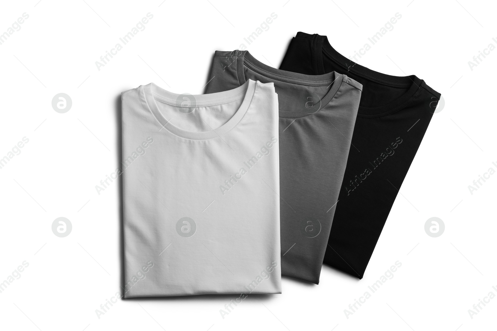 Image of Black, white and grey t-shirts on white background, top view. Mockup for design