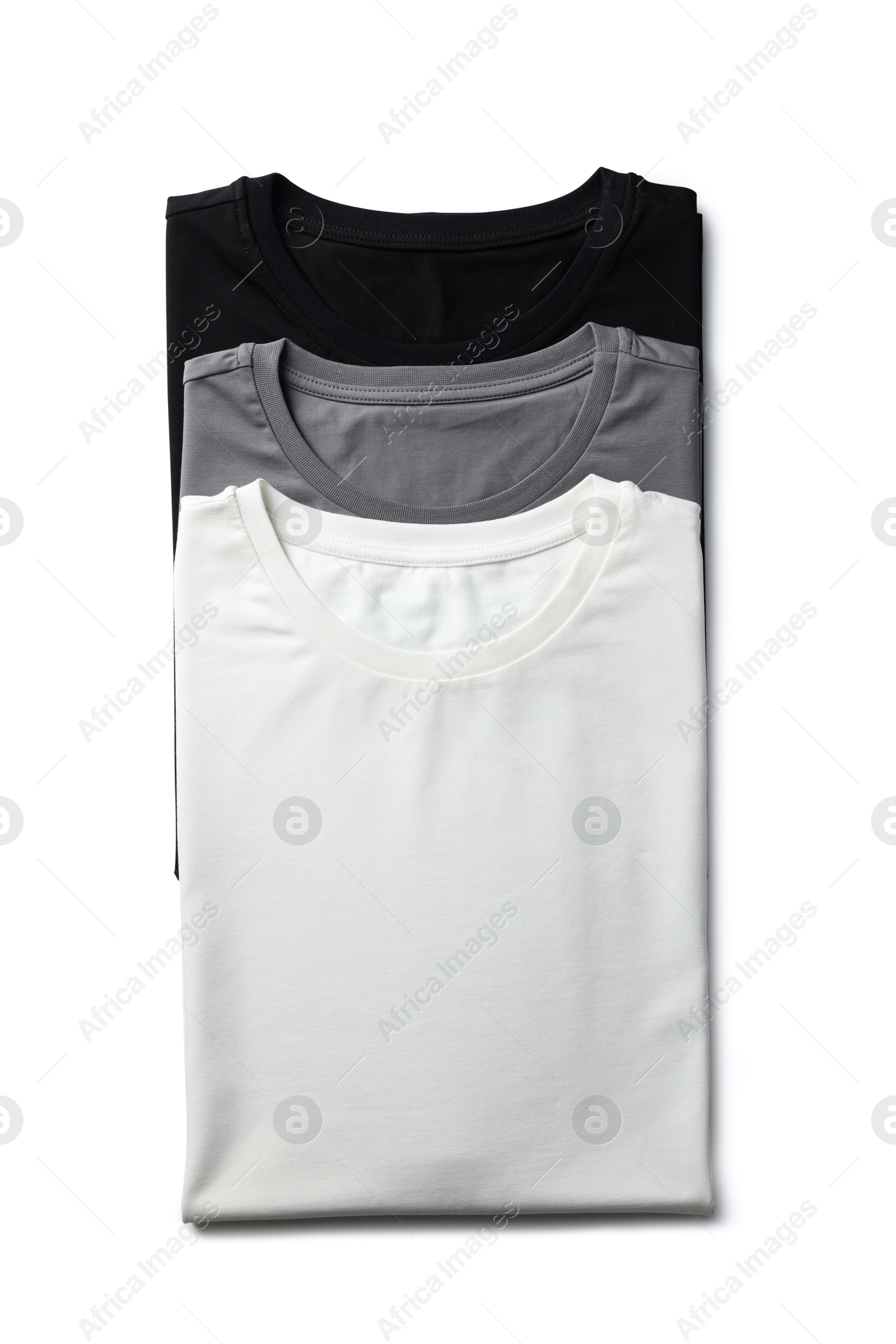 Image of Black, white and grey t-shirts on white background, top view. Mockup for design