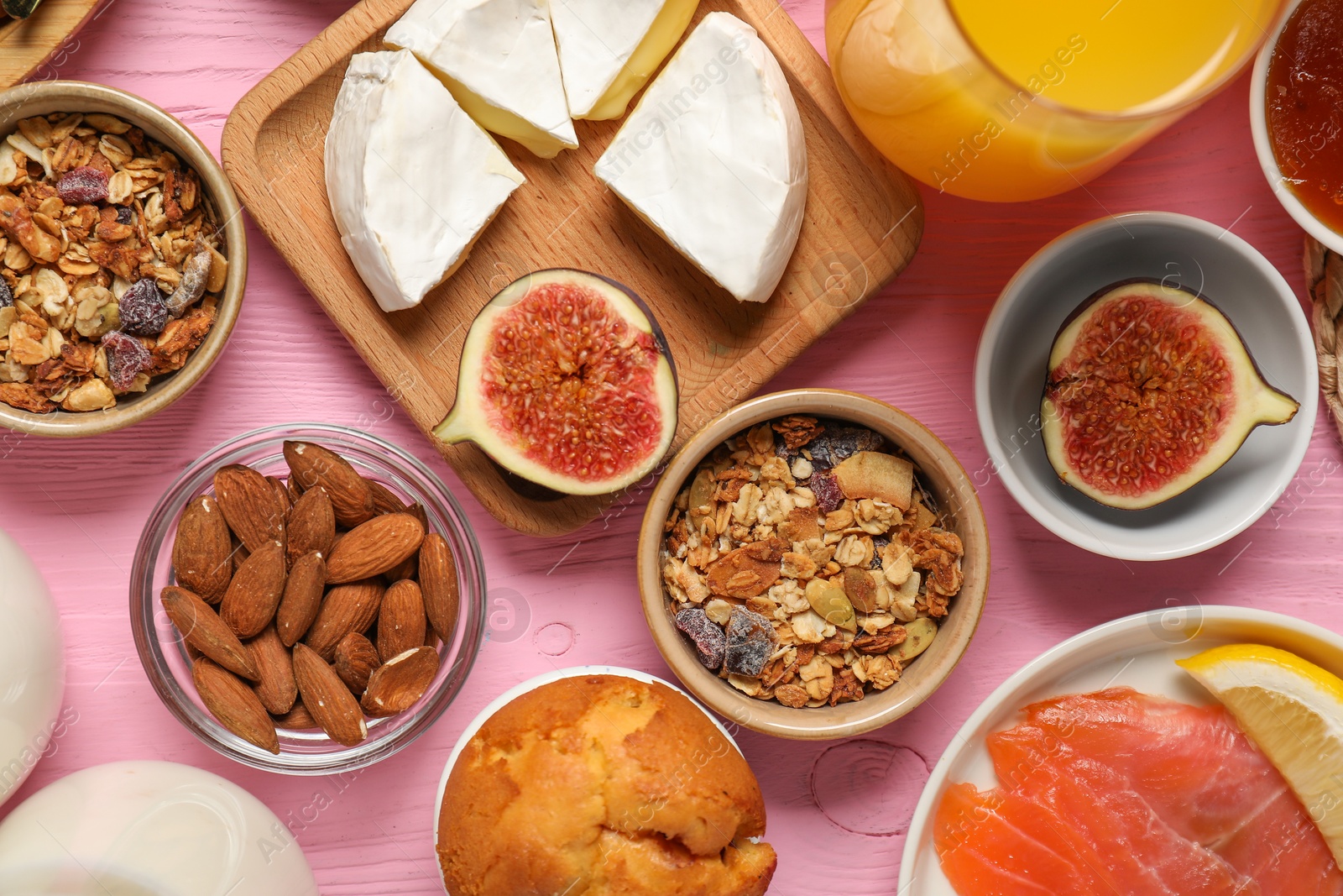 Photo of Different tasty food served for brunch on pink wooden table, flat lay