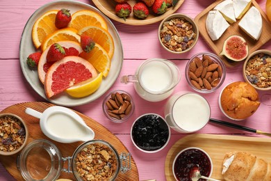 Photo of Different tasty food served for brunch on pink wooden table, flat lay