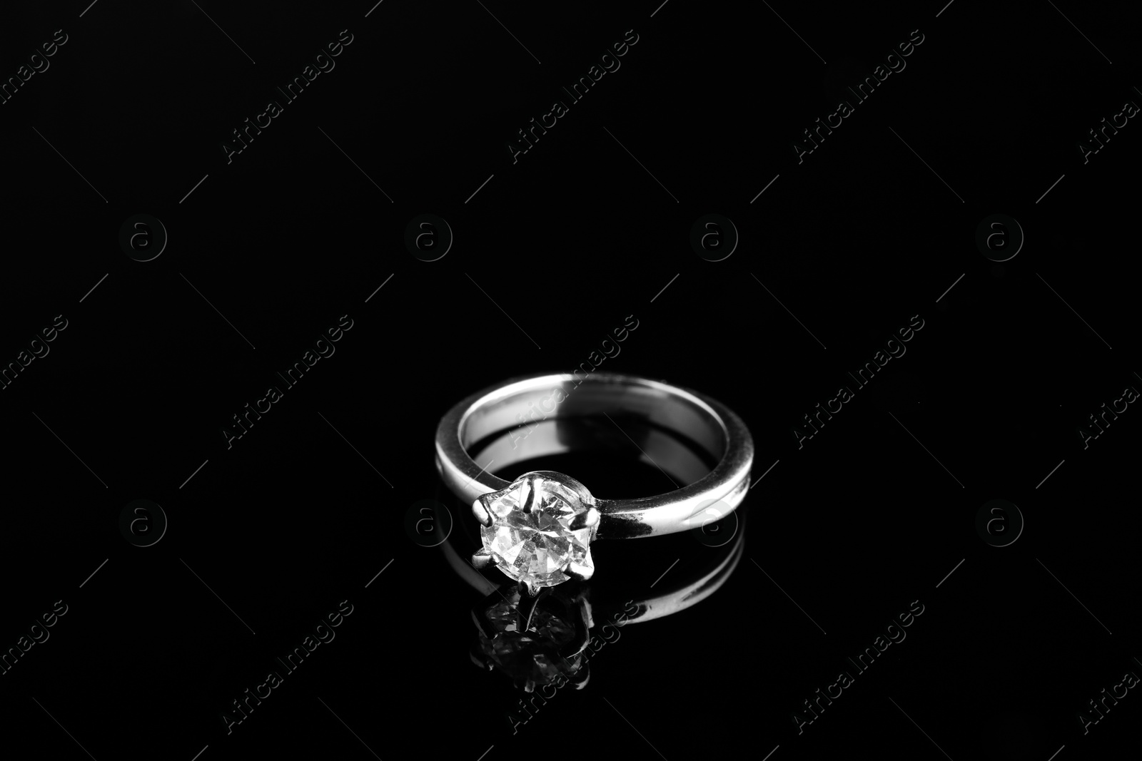 Photo of Beautiful bijouterie. Stylish ring on black background