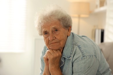 Photo of Loneliness concept. Sad senior woman at home