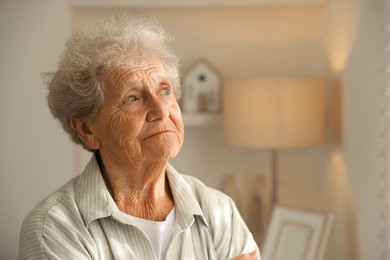 Photo of Loneliness concept. Sad senior woman at home