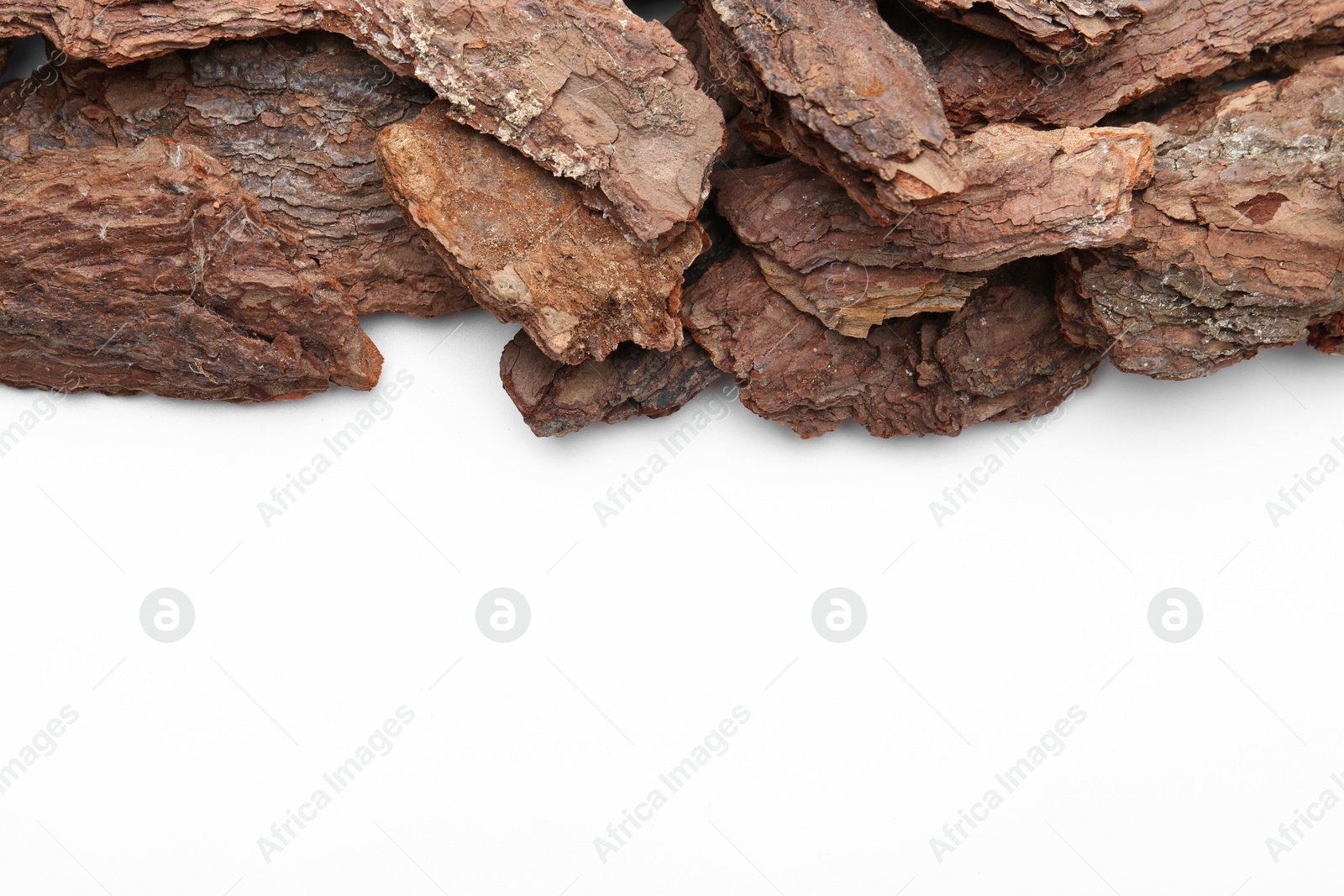 Photo of Pieces of tree bark on white background, top view. Space for text