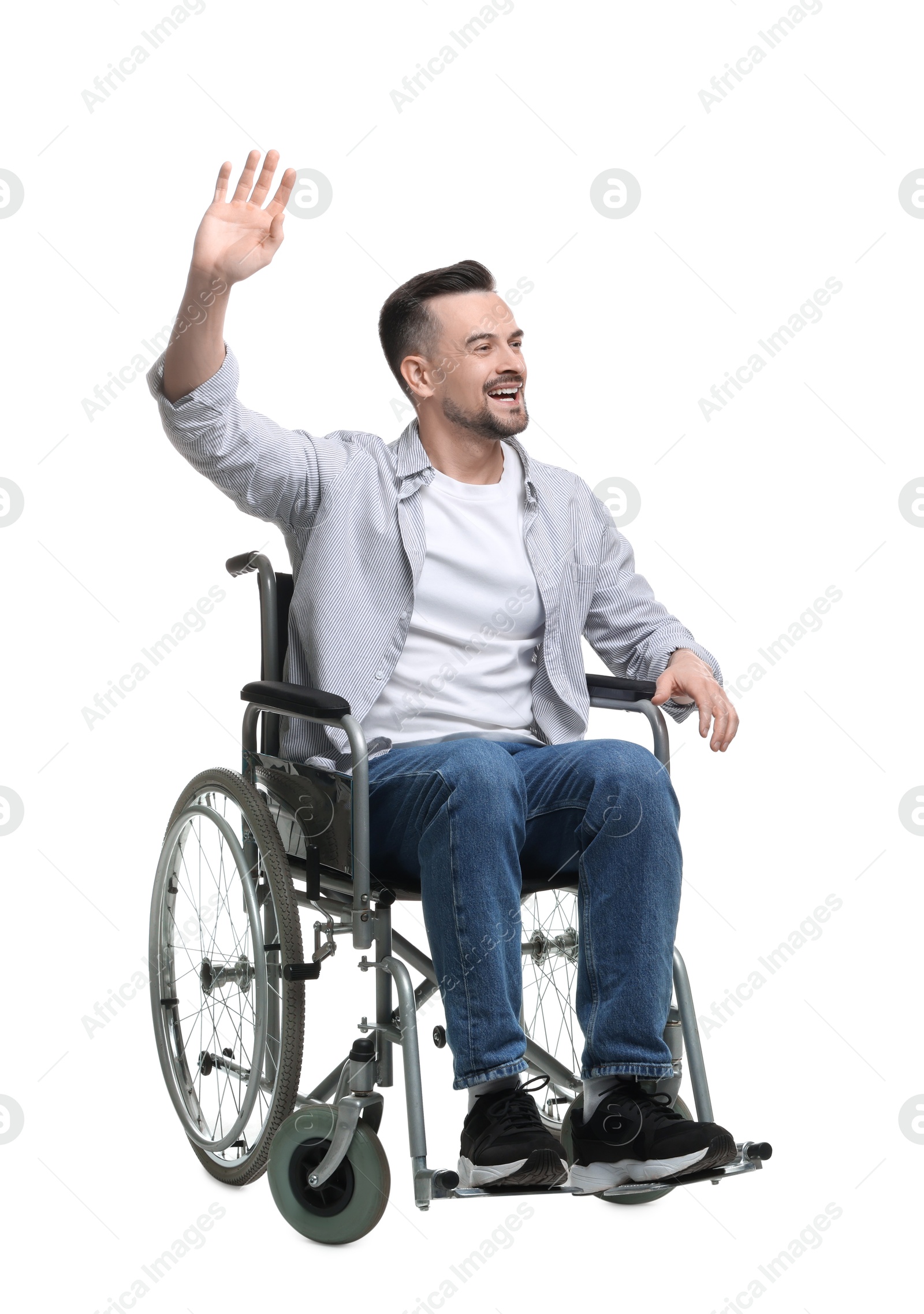 Photo of Man in wheelchair waving at someone on white background