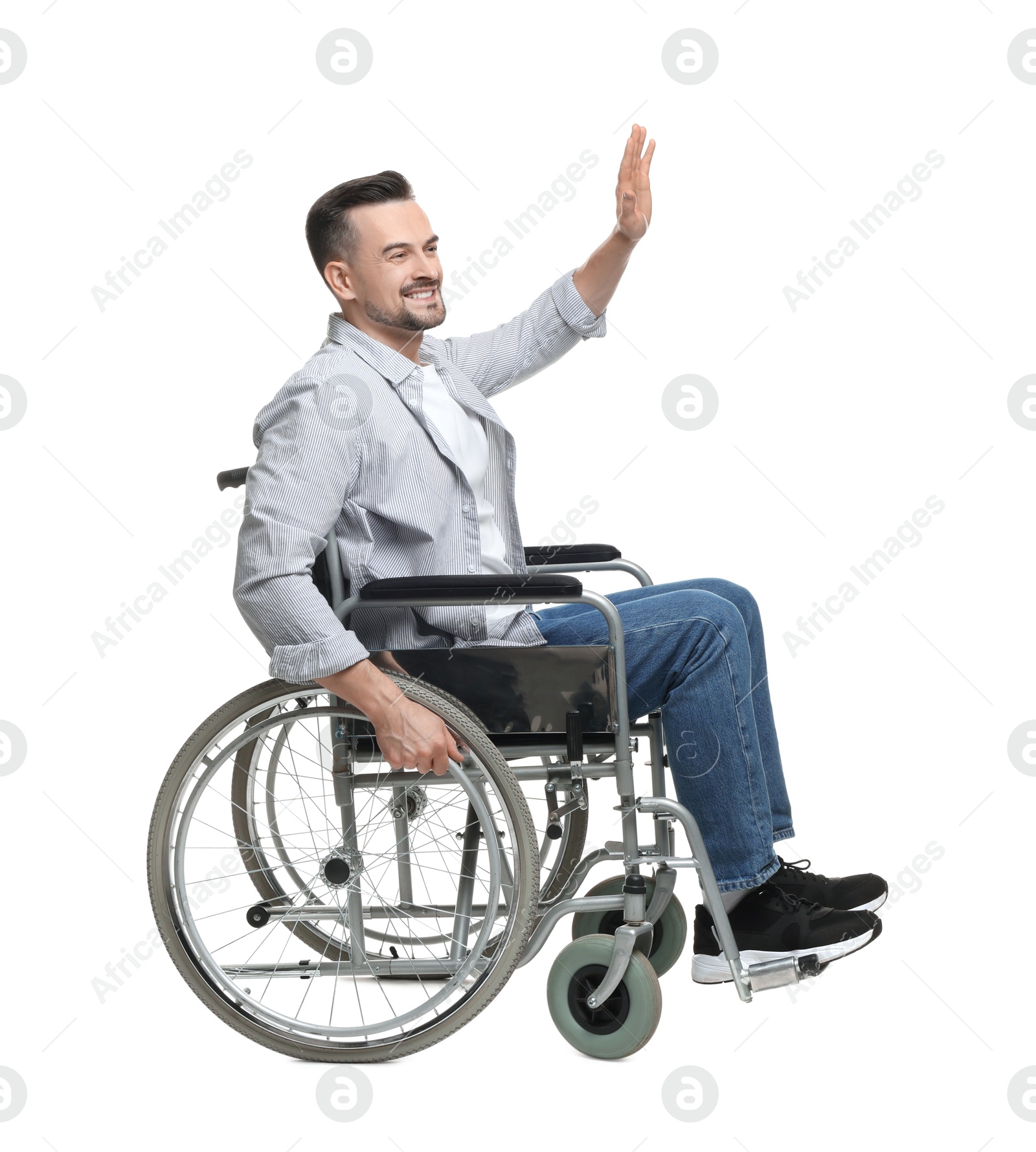 Photo of Man in wheelchair waving at someone on white background