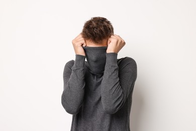 Photo of Portrait of scared young man on light background