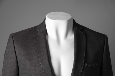 Photo of Semi-ready jacket on mannequin against grey background, closeup