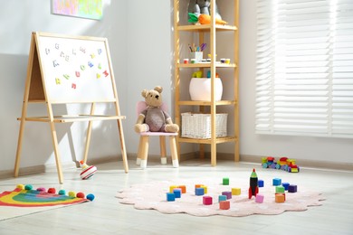 Photo of Beautiful child's room interior with toys and stylish furniture