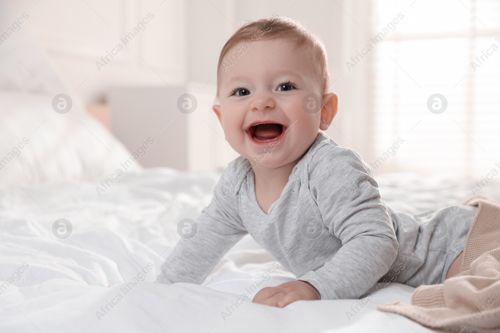 Photo of Cute little baby on bed at home