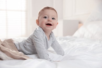 Photo of Cute little baby on bed at home