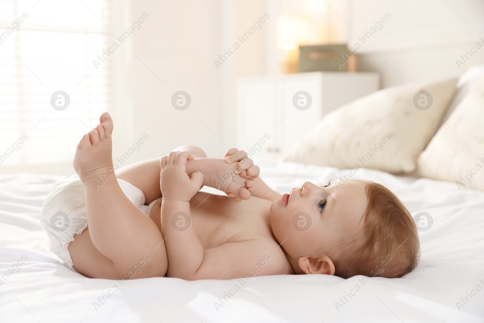 Photo of Cute little baby on bed at home