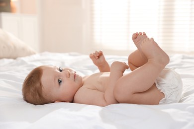 Photo of Cute little baby on bed at home