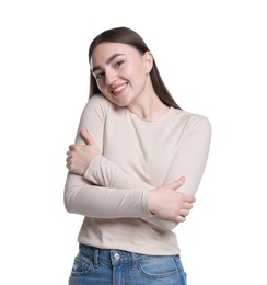 Photo of Charming young woman hugging herself on white background