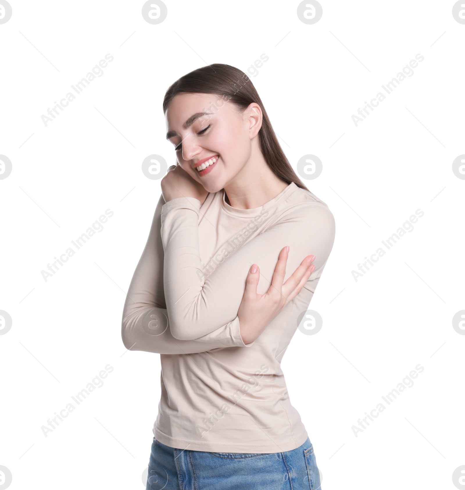 Photo of Charming young woman hugging herself on white background