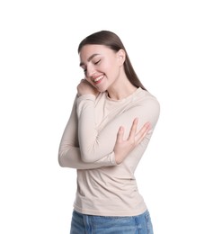 Photo of Charming young woman hugging herself on white background