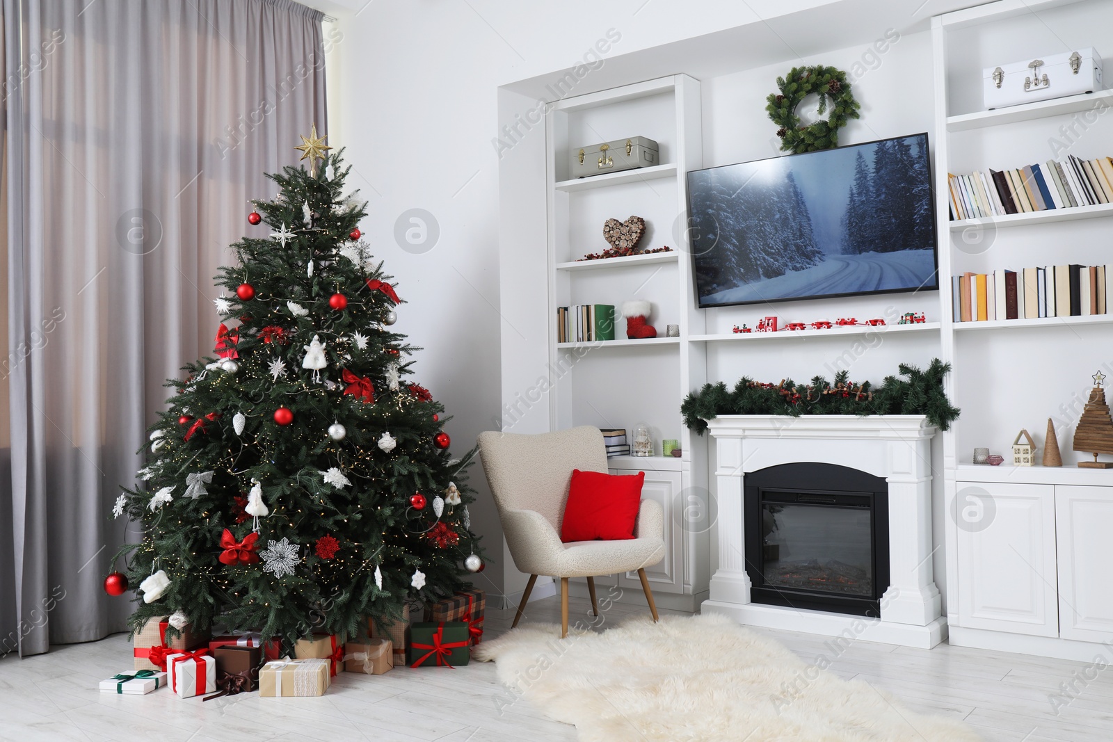 Photo of Beautifully decorated Christmas tree near fireplace in room. Festive interior design