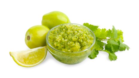 Photo of Delicious homemade green salsa and ingredients isolated on white